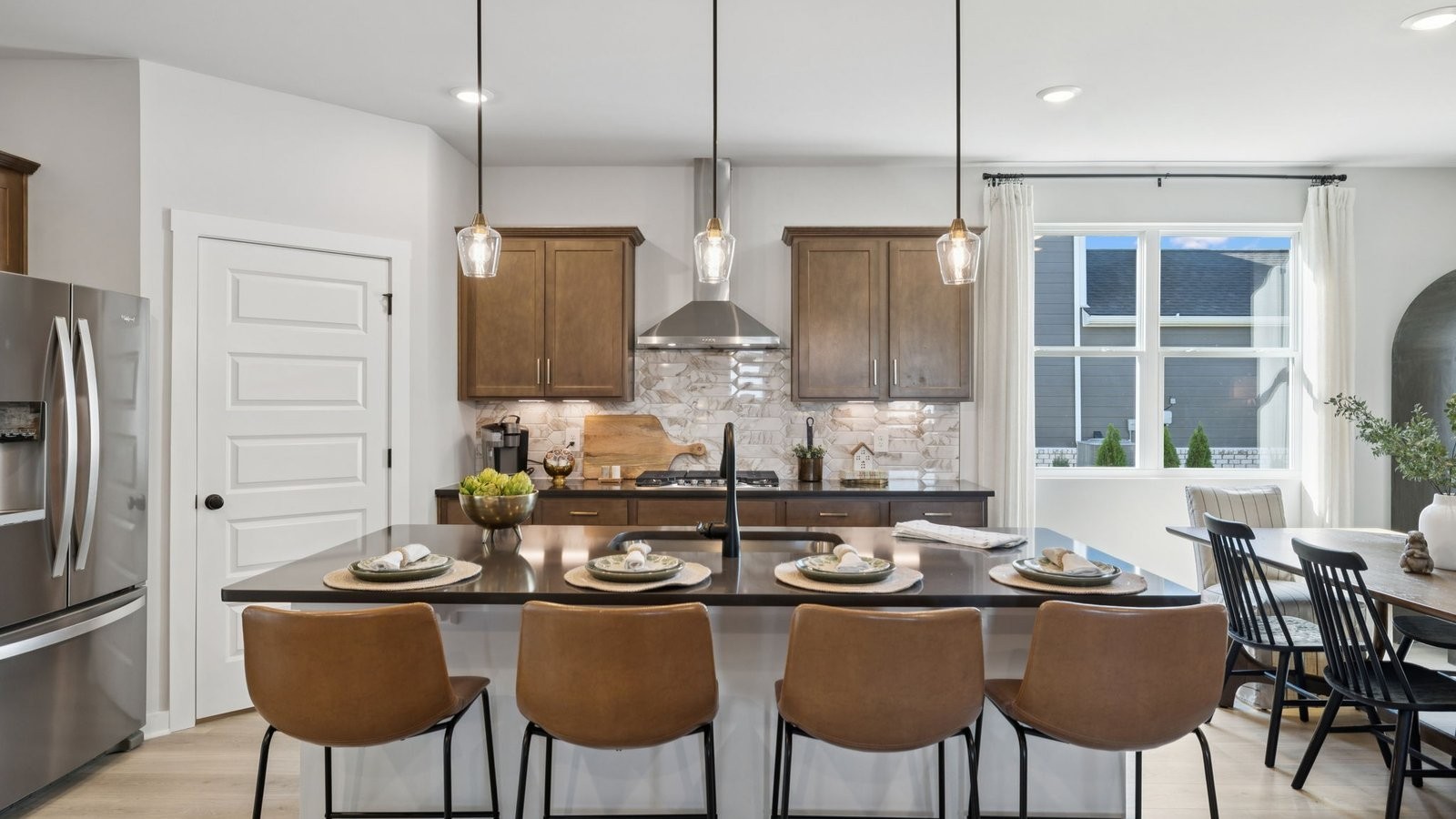 305 Harvest Point Boulevard Spring Hill, TN 37174 - Photo 24 of 48 a kitchen with stainless steel appliances granite countertop a table chairs stove and refrigerator