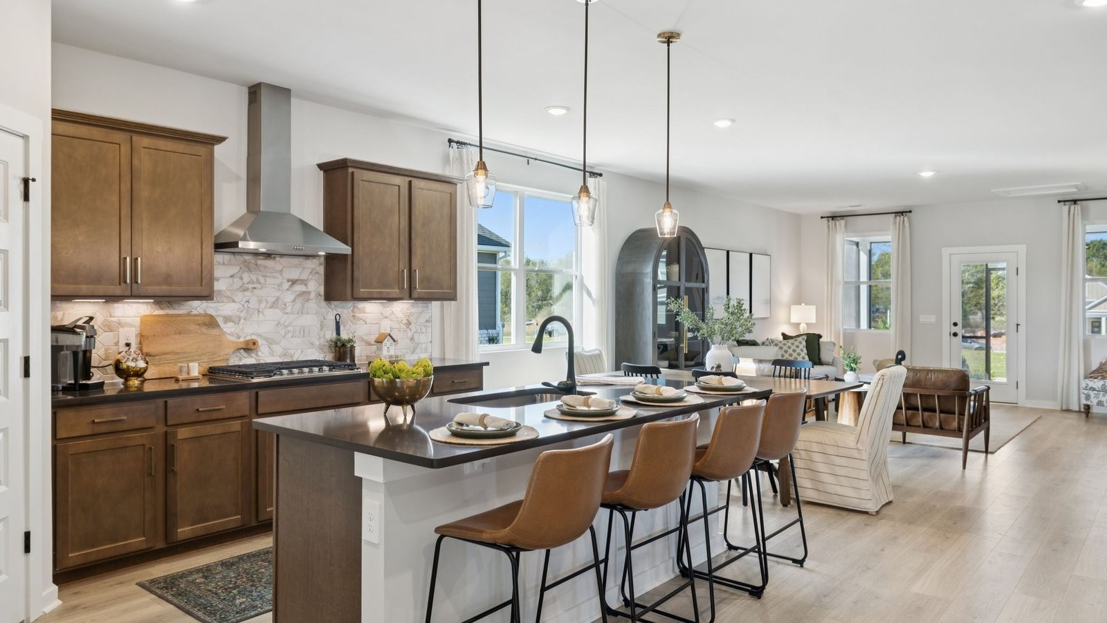 305 Harvest Point Boulevard Spring Hill, TN 37174 - Photo 26 of 48 a kitchen with stainless steel appliances granite countertop a stove a sink a dining table and chairs