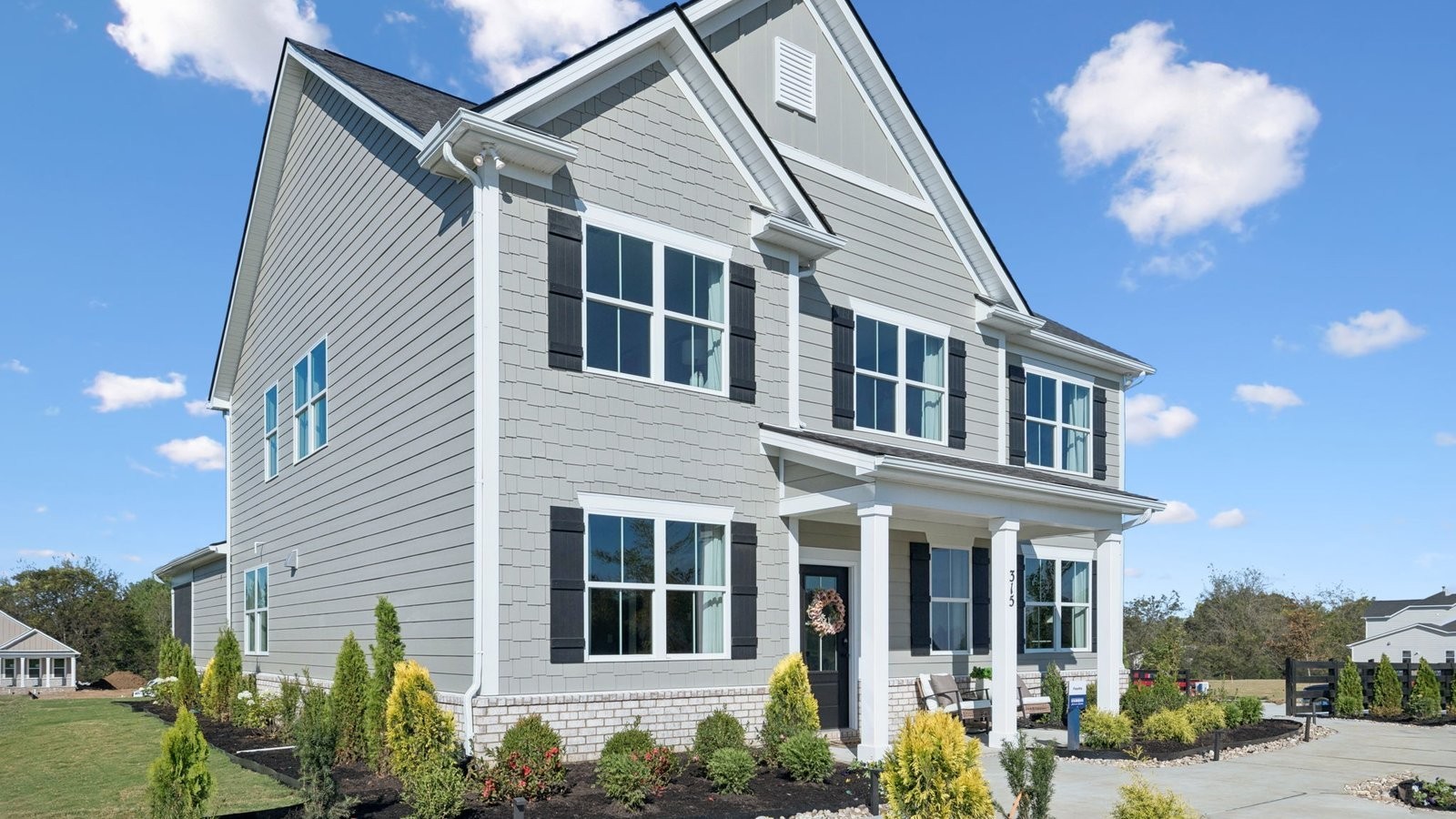 305 Harvest Point Boulevard Spring Hill, TN 37174 - Photo 6 of 48 a front view of a house with a yard