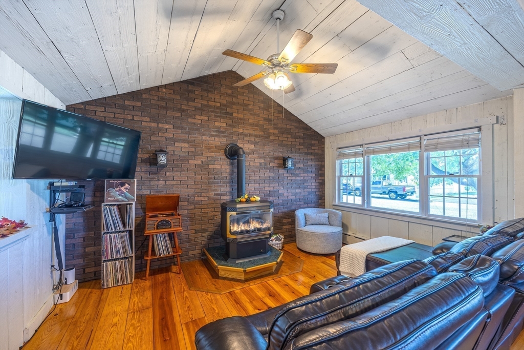 148 Yale Street Ludlow, MA 01056 - Photo 17 of 39 a living room with furniture a fireplace and a large window