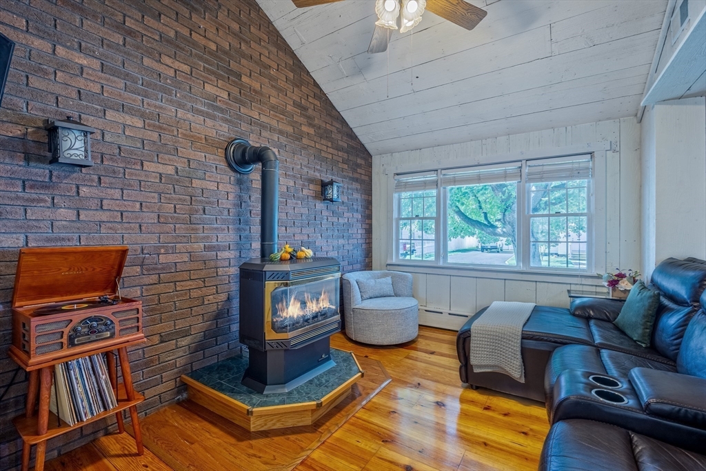 148 Yale Street Ludlow, MA 01056 - Photo 18 of 39 a living room with furniture a flat screen tv and a fireplace