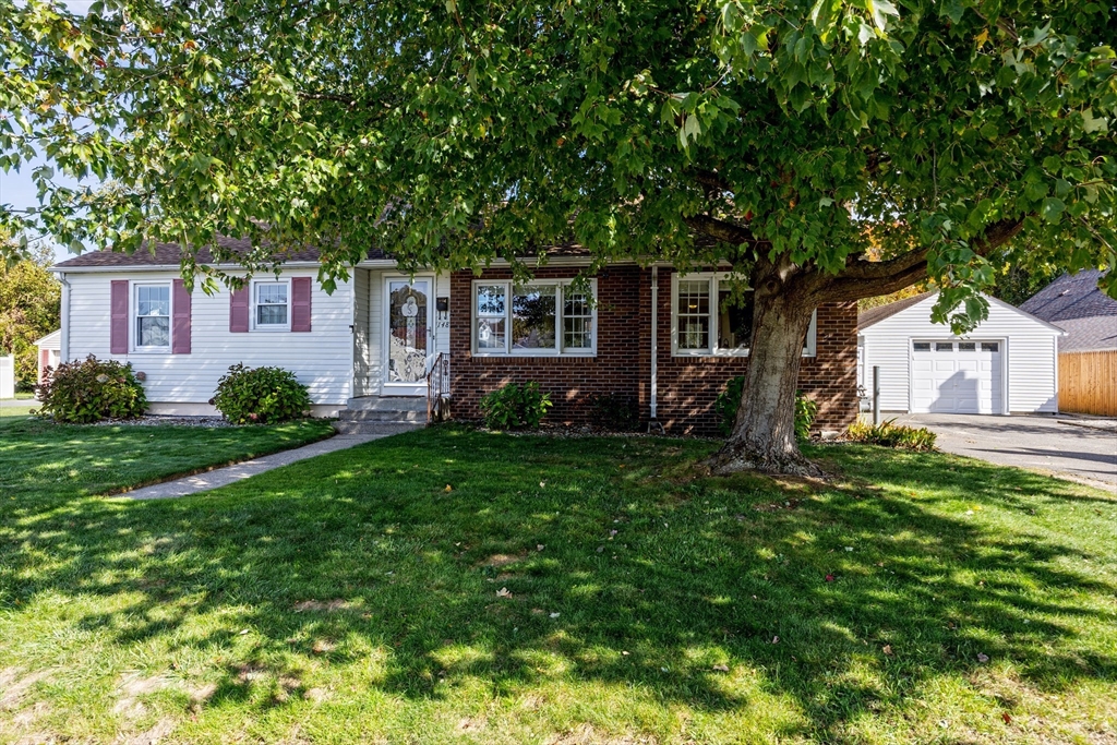 148 Yale Street Ludlow, MA 01056 - Photo 2 of 39 a view of a yard in front of a house with plants and large tree