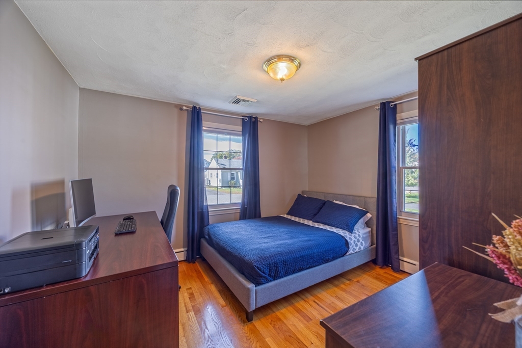 148 Yale Street Ludlow, MA 01056 - Photo 25 of 39 a bedroom with a bed and wooden floor