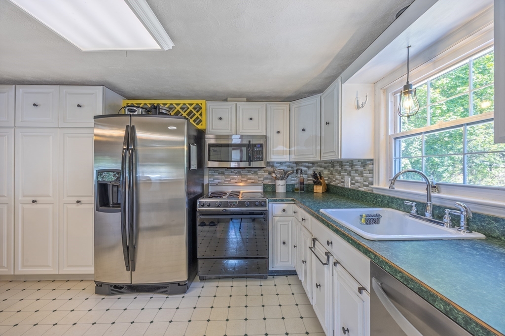 148 Yale Street Ludlow, MA 01056 - Photo 7 of 39 a kitchen with stainless steel appliances granite countertop a sink stove and refrigerator