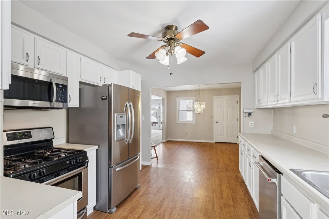 611 Wilson Street Struthers, OH 44471 - Photo 2 of 44 Kitchen featuring appliances with stainless steel finishes, light countertops, white cabinets, and light wood-type flooring