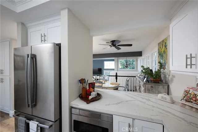 a kitchen with a refrigerator and a table
