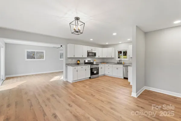 a view of kitchen with wooden floor