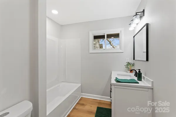 a bathroom with a bathtub sink and toilet