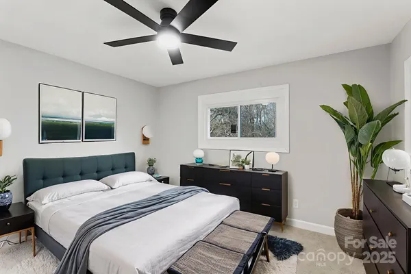 a bedroom with bed and a potted plant