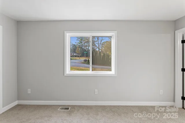a view of a livingroom with a ceiling fan and window