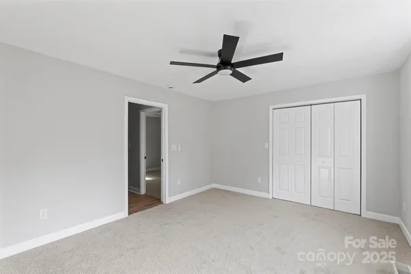 a view of room with window and ceiling fan