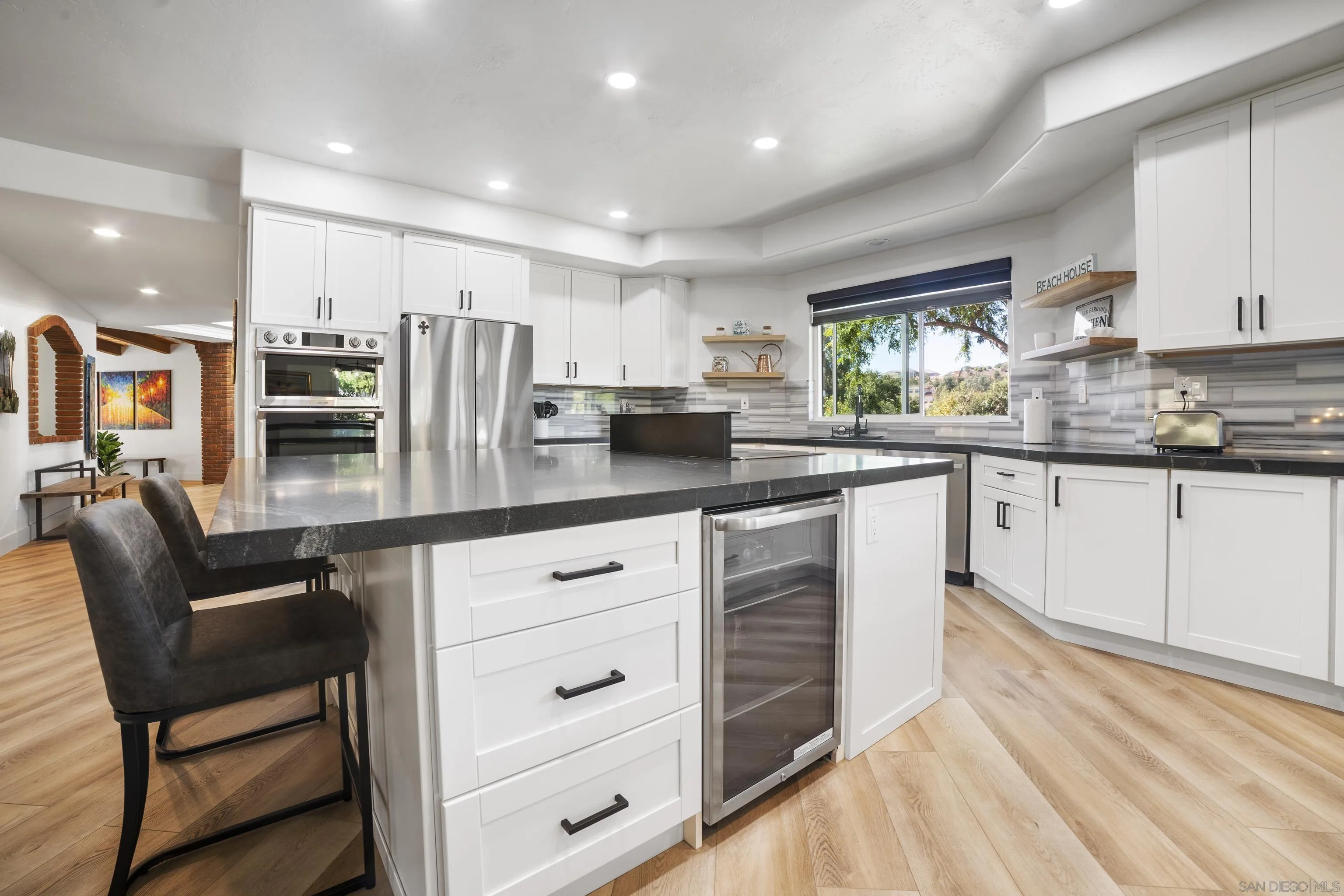 4062 La Canada Road Fallbrook, CA 92028 - Photo 16 of 63 a kitchen with stainless steel appliances granite countertop a table chairs stove microwave and cabinets