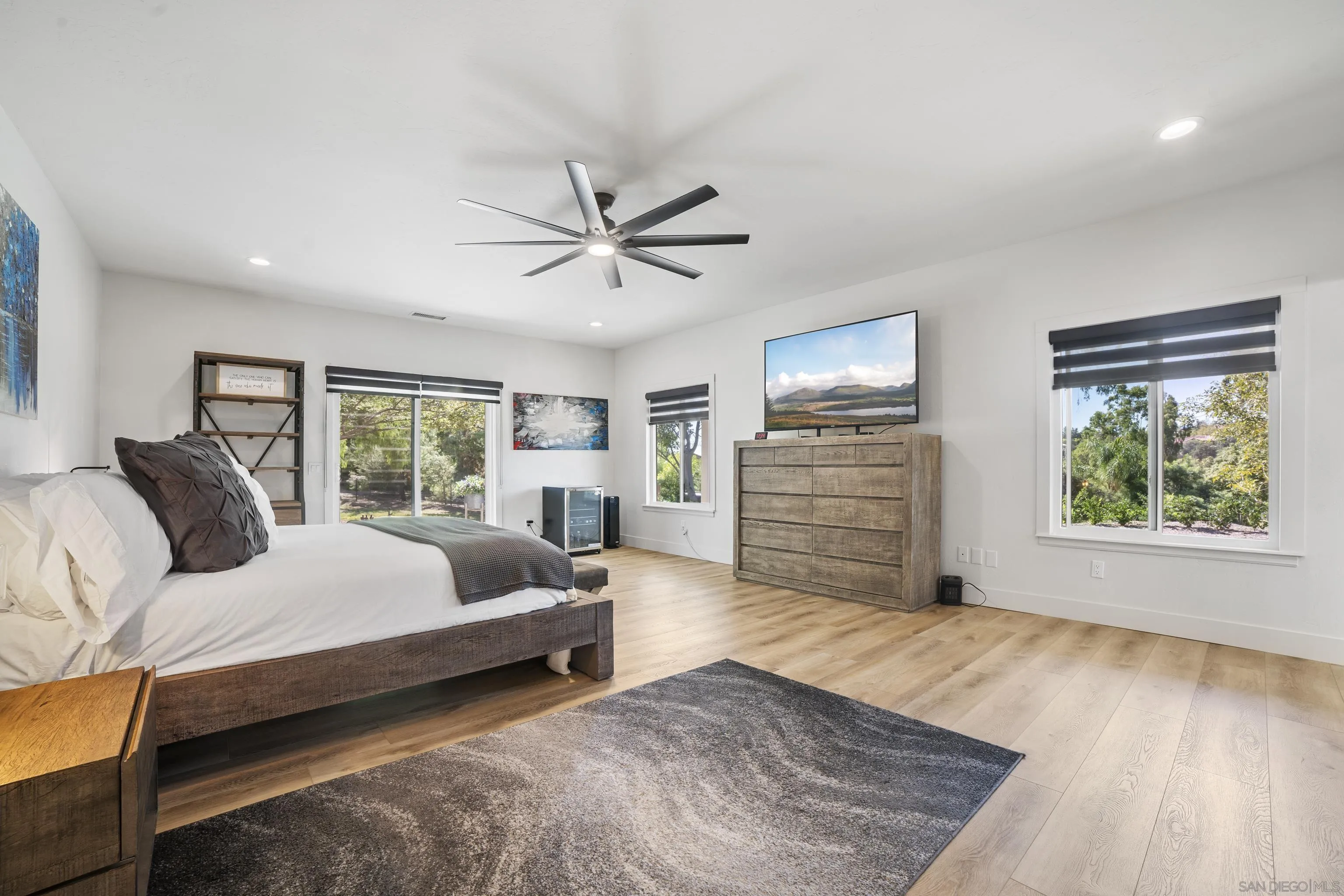 4062 La Canada Road Fallbrook, CA 92028 - Photo 21 of 63 a spacious bedroom with a large bed a chandelier and windows