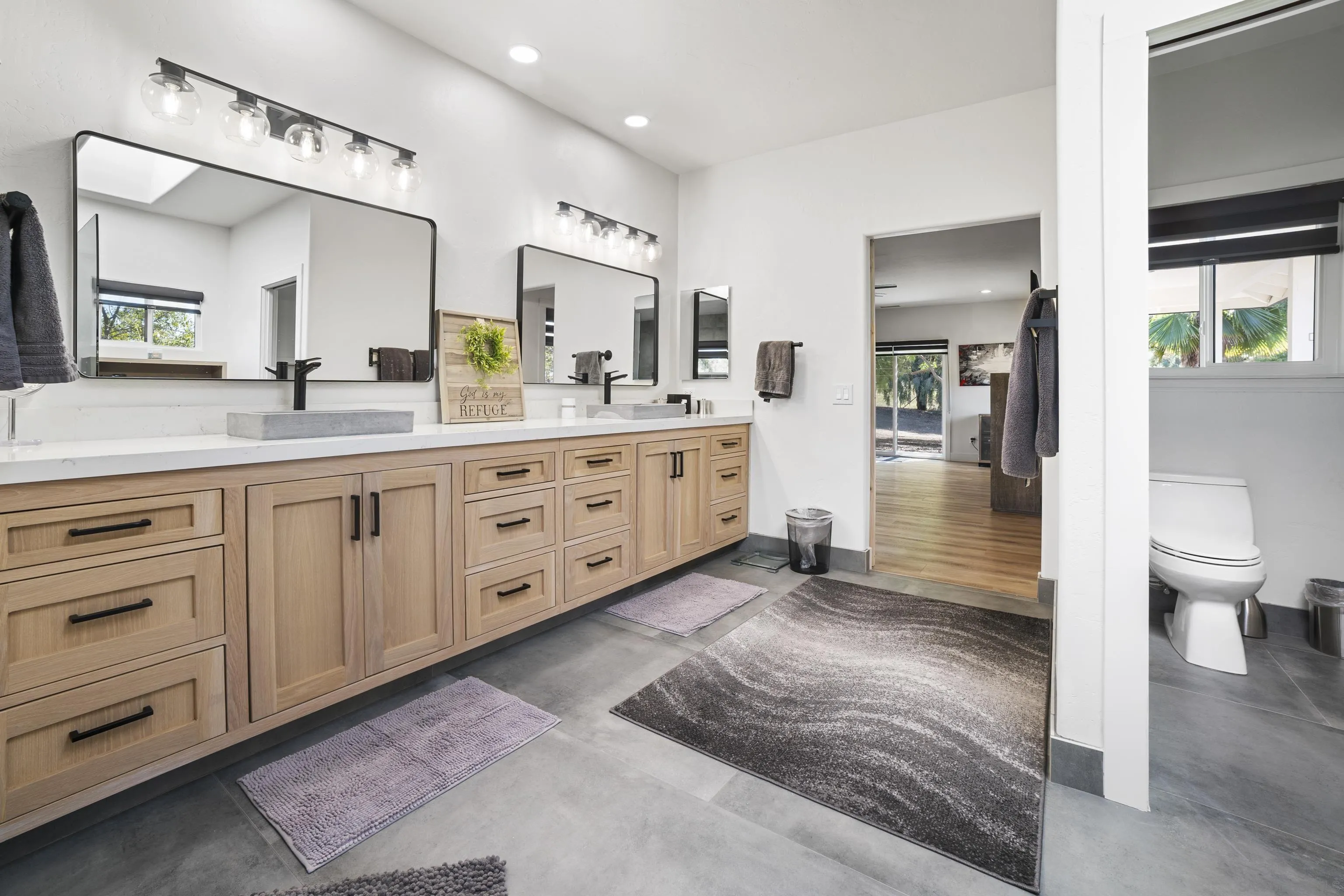 4062 La Canada Road Fallbrook, CA 92028 - Photo 23 of 63 a spacious bathroom with a granite countertop sink mirror and toilet