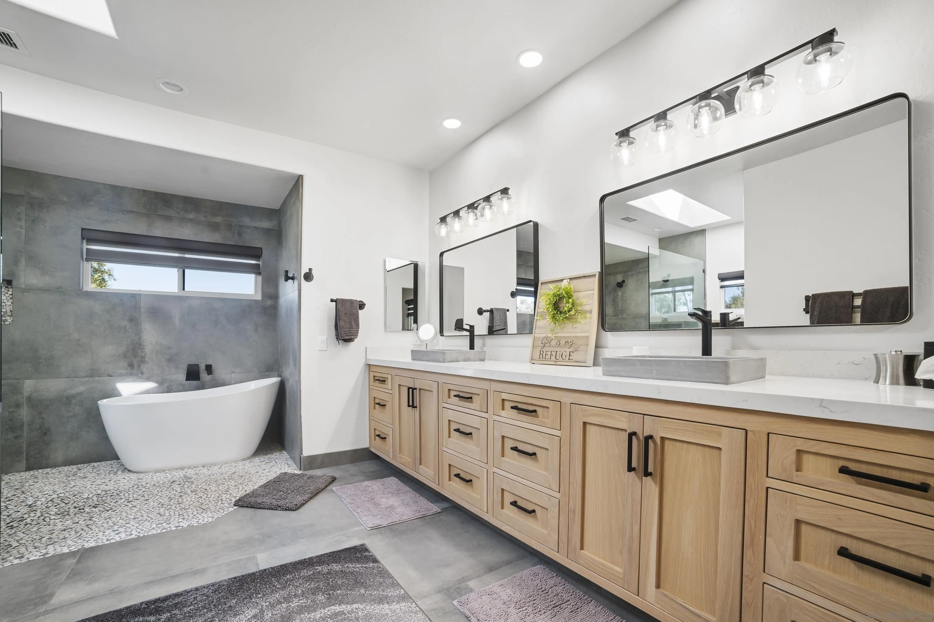 4062 La Canada Road Fallbrook, CA 92028 - Photo 24 of 63 a spacious bathroom with a double vanity sink a mirror and a bathtub