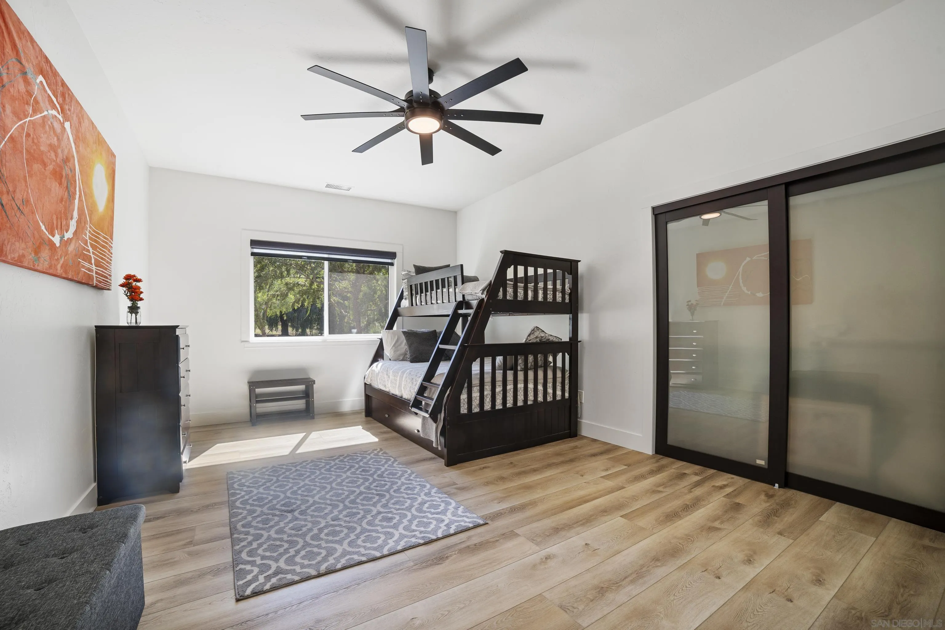 4062 La Canada Road Fallbrook, CA 92028 - Photo 33 of 63 a bedroom with a bed and wooden floor