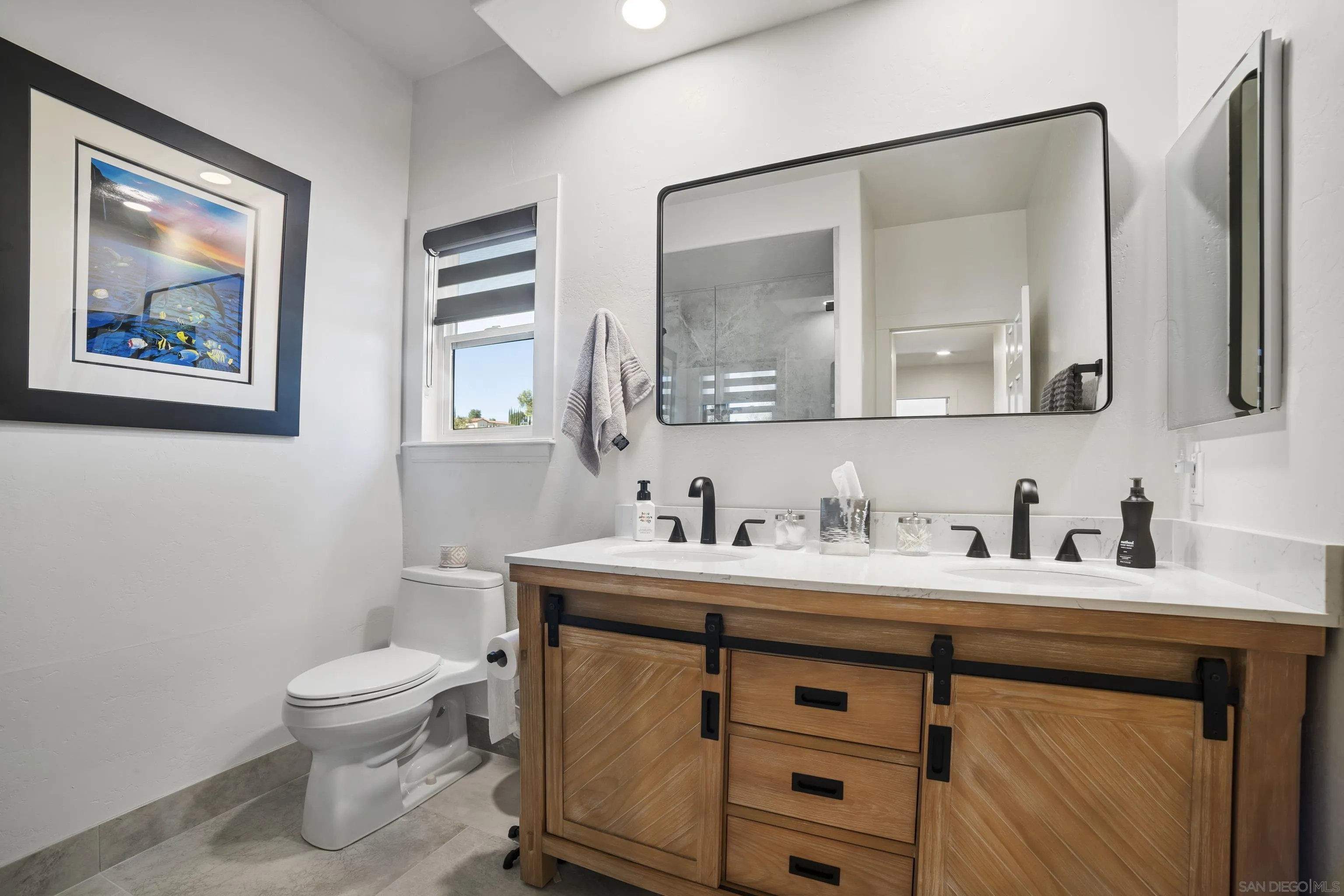4062 La Canada Road Fallbrook, CA 92028 - Photo 36 of 63 a bathroom with a toilet a sink a vanity and mirror