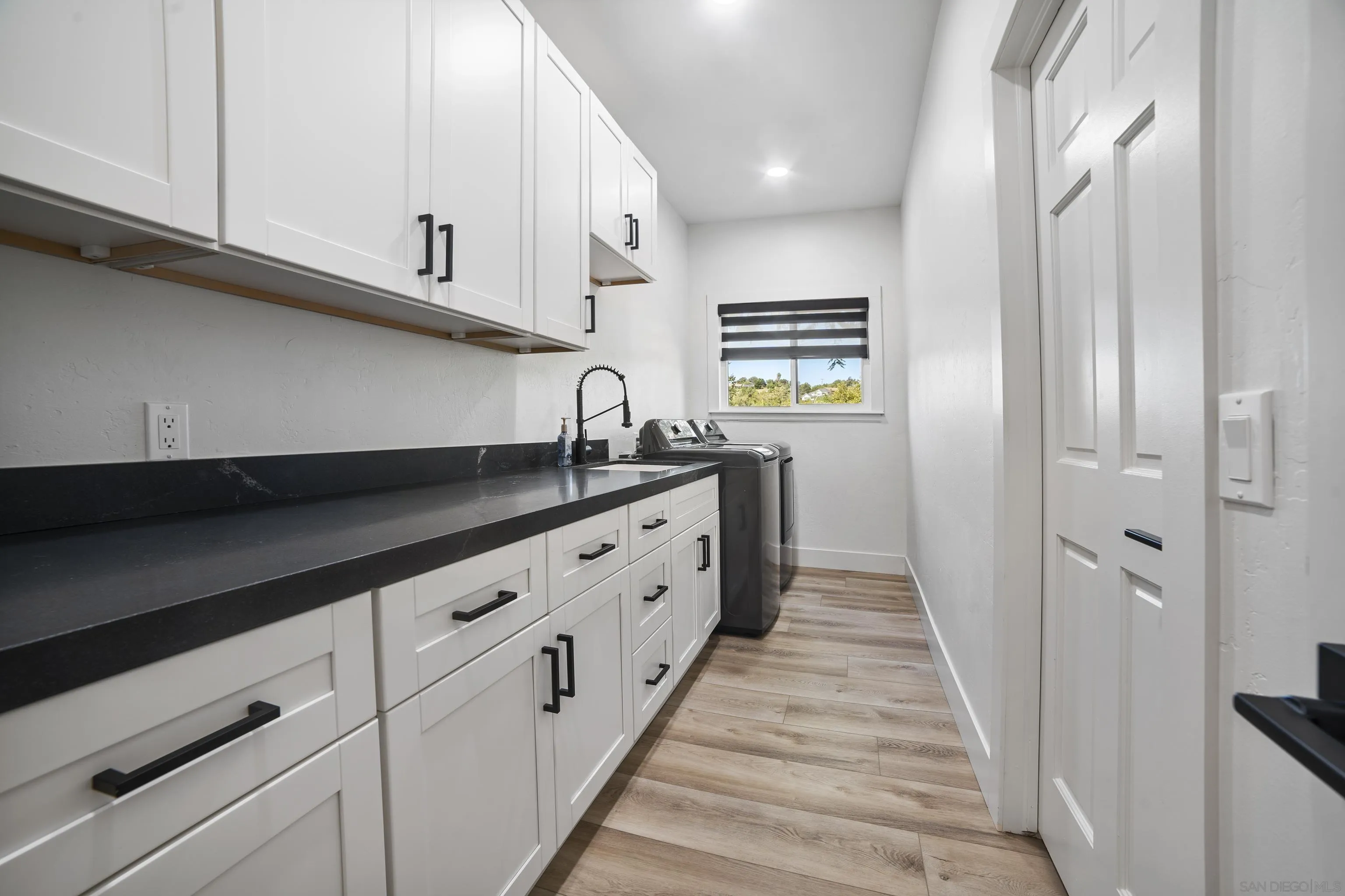 4062 La Canada Road Fallbrook, CA 92028 - Photo 38 of 63 a kitchen with granite countertop white cabinets and sink