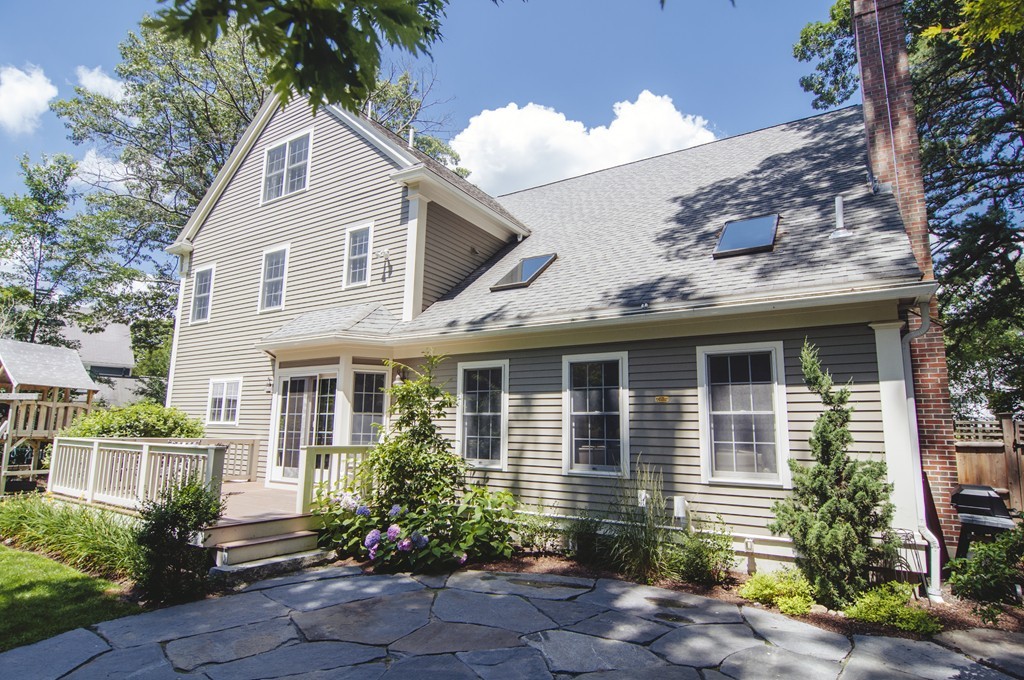 52 Locust Avenue Lexington, MA 02421 - Photo 24 of 28 a view of a white house next to a yard and potted plants