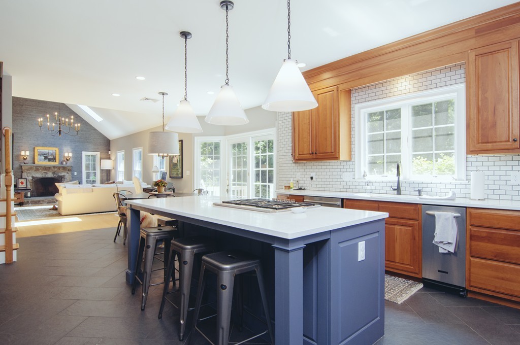 52 Locust Avenue Lexington, MA 02421 - Photo 5 of 28 a kitchen with a stove a sink dishwasher a dining table and chairs with wooden floor