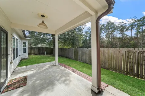a view of a porch with furniture and garden