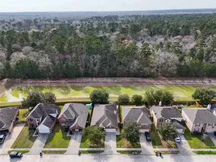 an aerial view of residential houses with outdoor space and swimming pool