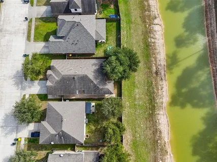 an aerial view of residential houses with outdoor space and swimming pool