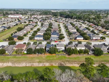 an aerial view of residential houses with outdoor space and swimming pool