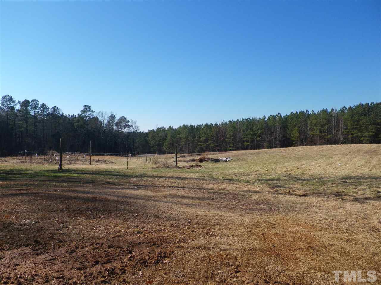 a view of a field with trees in the background