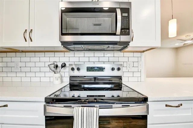 a stove top oven sitting inside of a kitchen