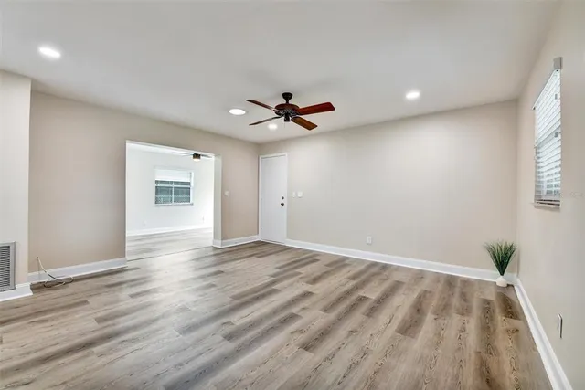 wooden floor in an empty room with a window