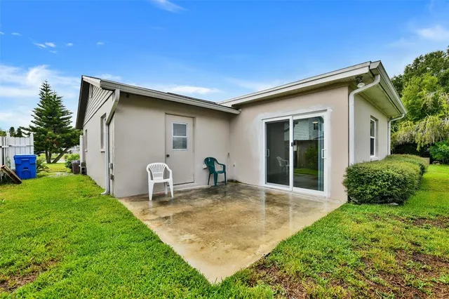 a backyard of a house with table and chairs