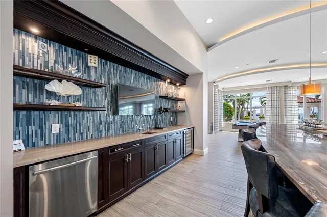 a kitchen with stainless steel appliances granite countertop lots of counter top space and wooden floor