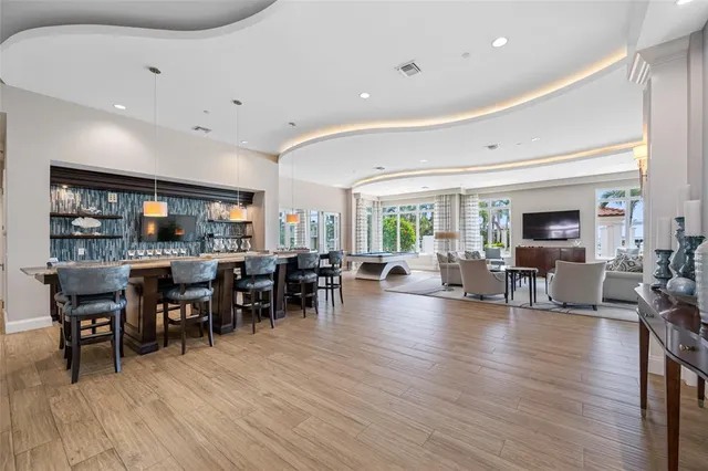a living room with patio furniture and a flat screen tv