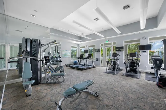 a living room with lots of furniture and gym equipment