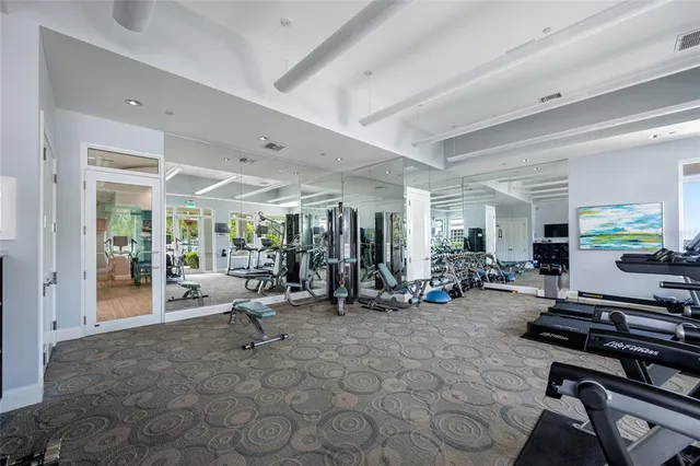 a room with gym equipment and a large window