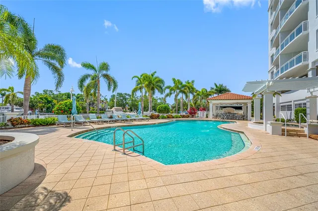 a view of swimming pool with outdoor seating and plants