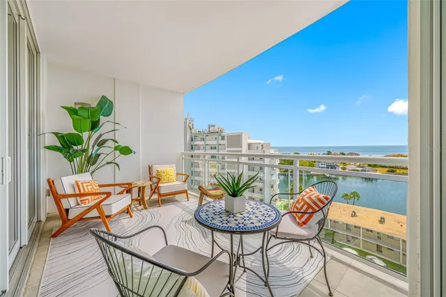 a view of a balcony with furniture and a potted plant
