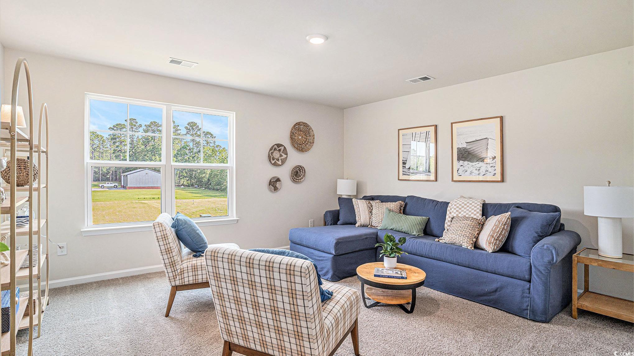183 Pampa Drive Loris, SC 29569 - Photo 11 of 22 Living area with light colored carpet and baseboards