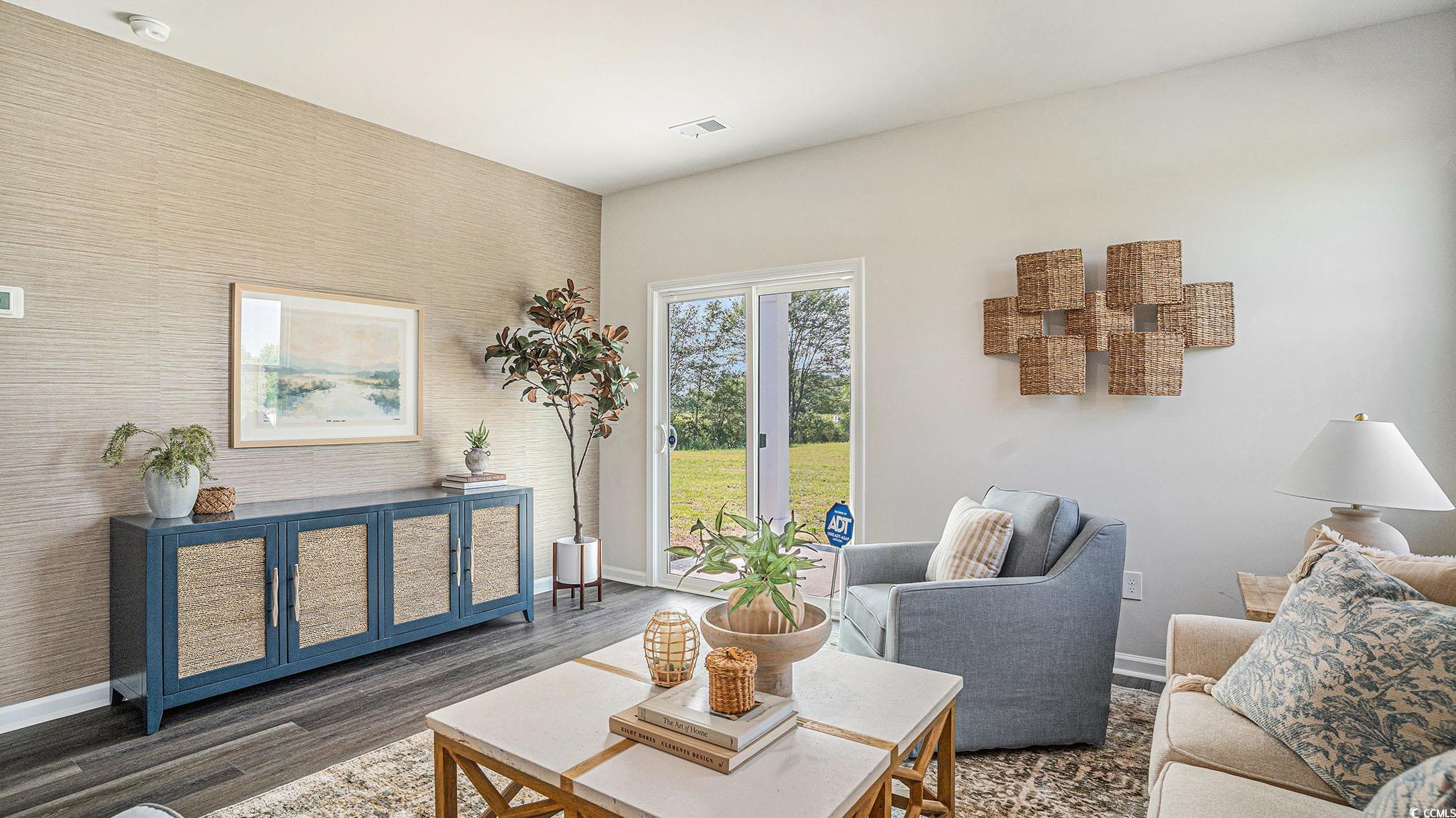 183 Pampa Drive Loris, SC 29569 - Photo 6 of 22 Living area featuring an accent wall and wood finished floors