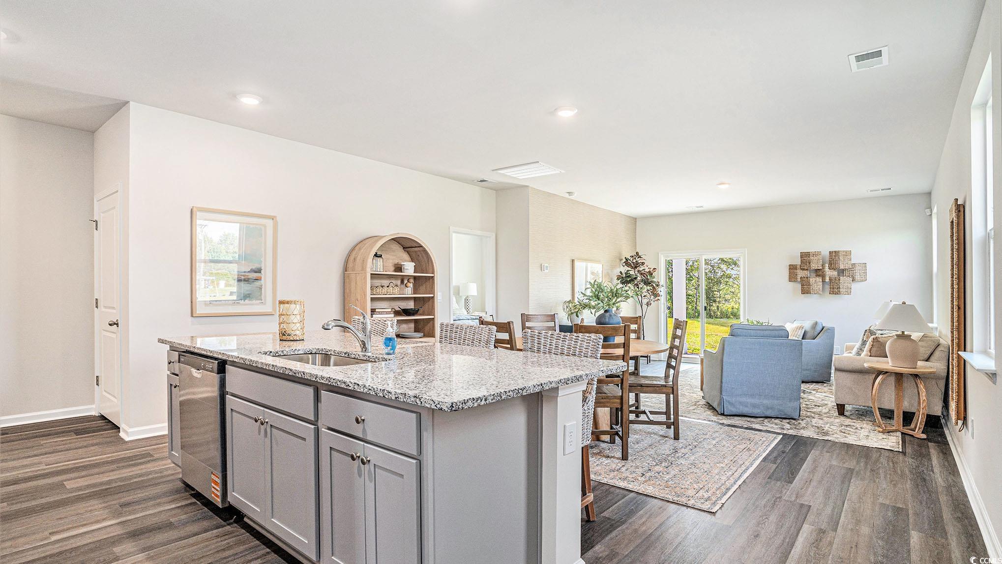 183 Pampa Drive Loris, SC 29569 - Photo 22 of 22 Kitchen with gray cabinetry, light stone counters, open floor plan, a center island with sink, and stainless steel dishwasher