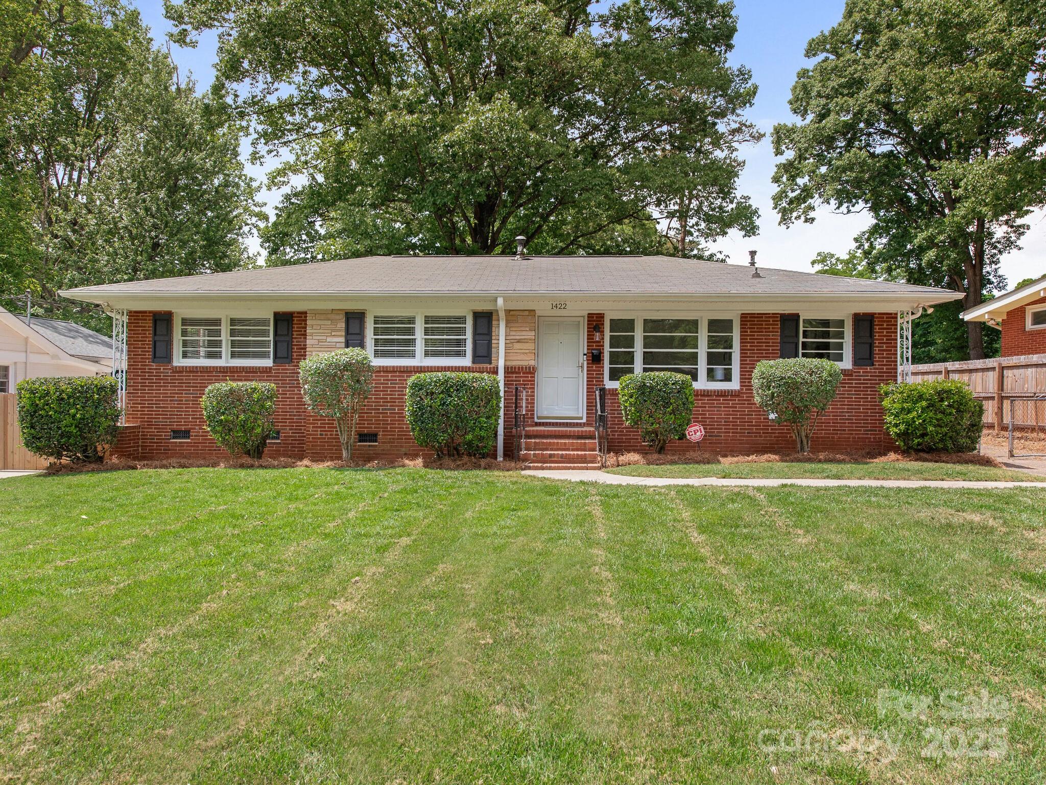 1422 Burnley Road Charlotte, NC 28210 - Photo 1 of 29 front view of a house that has a yard