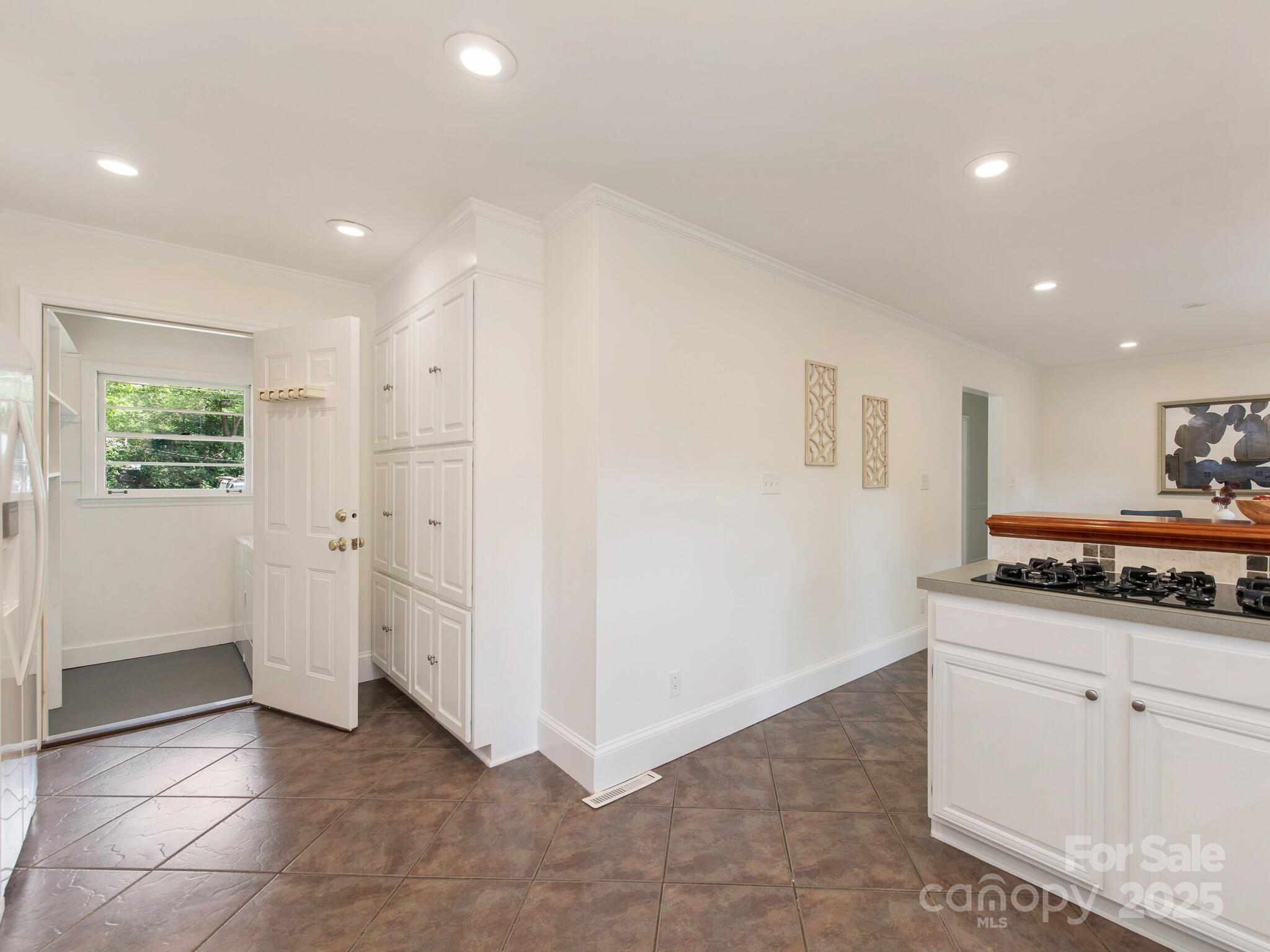 1422 Burnley Road Charlotte, NC 28210 - Photo 11 of 29 a view of a kitchen with white cabinets