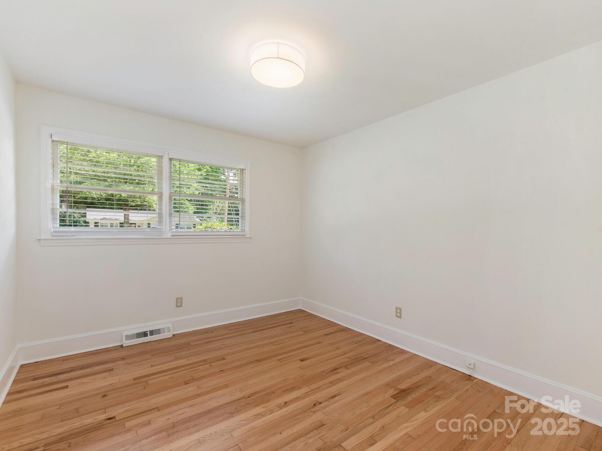 1422 Burnley Road Charlotte, NC 28210 - Photo 13 of 29 wooden floor in an empty room with a window