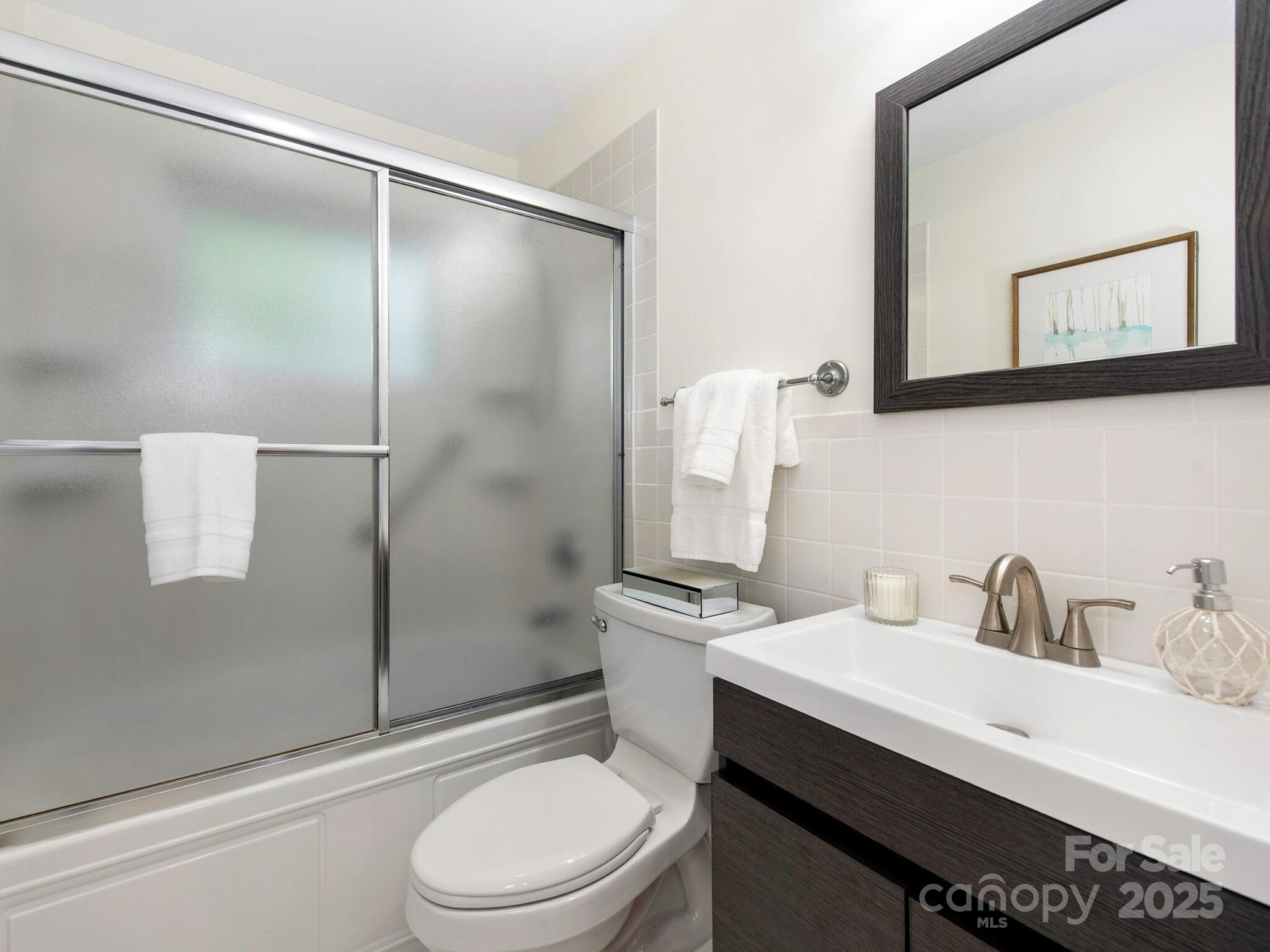 1422 Burnley Road Charlotte, NC 28210 - Photo 15 of 29 a bathroom with a sink toilet and shower