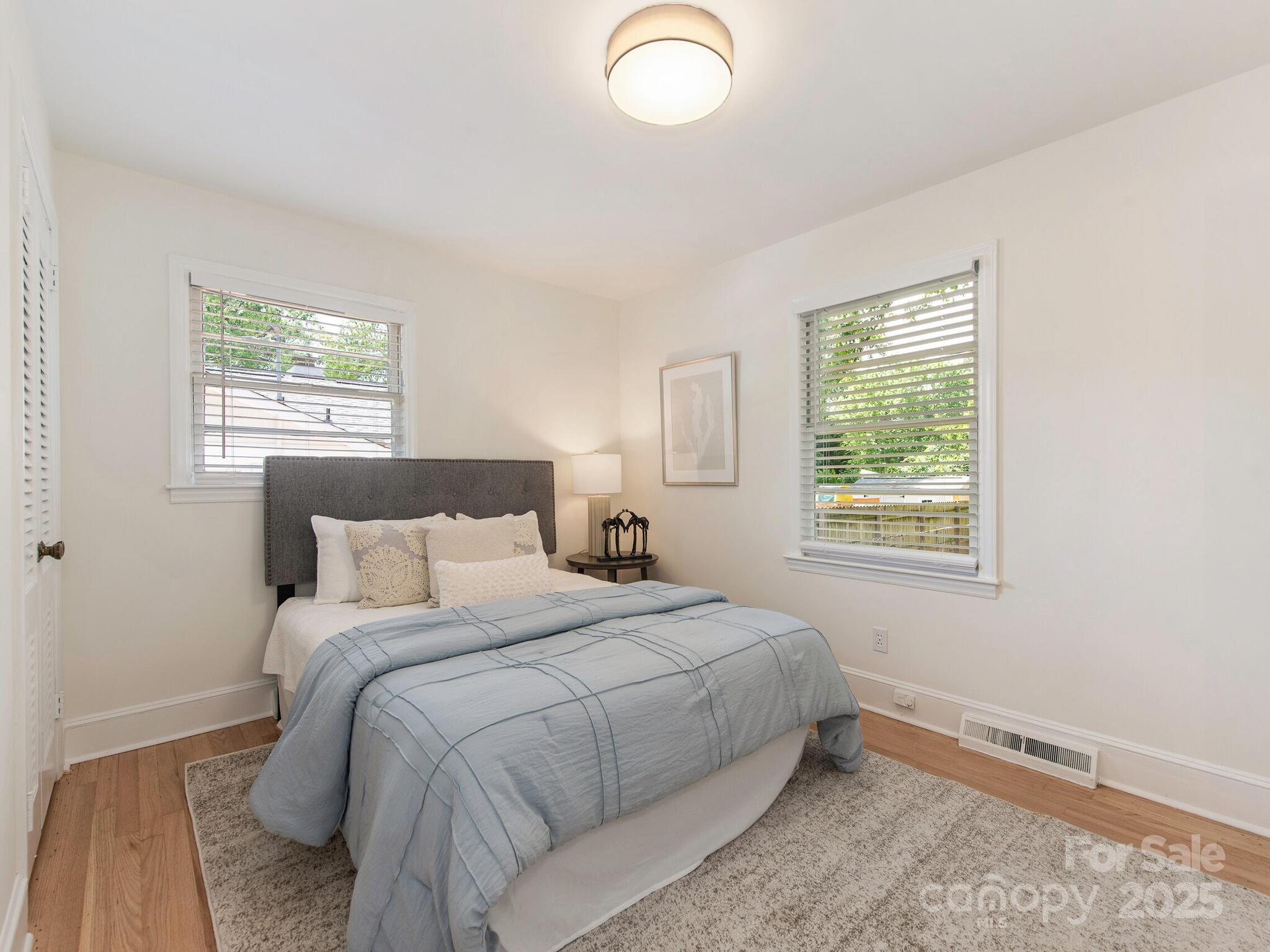 1422 Burnley Road Charlotte, NC 28210 - Photo 18 of 29 a bedroom with a bed and a window