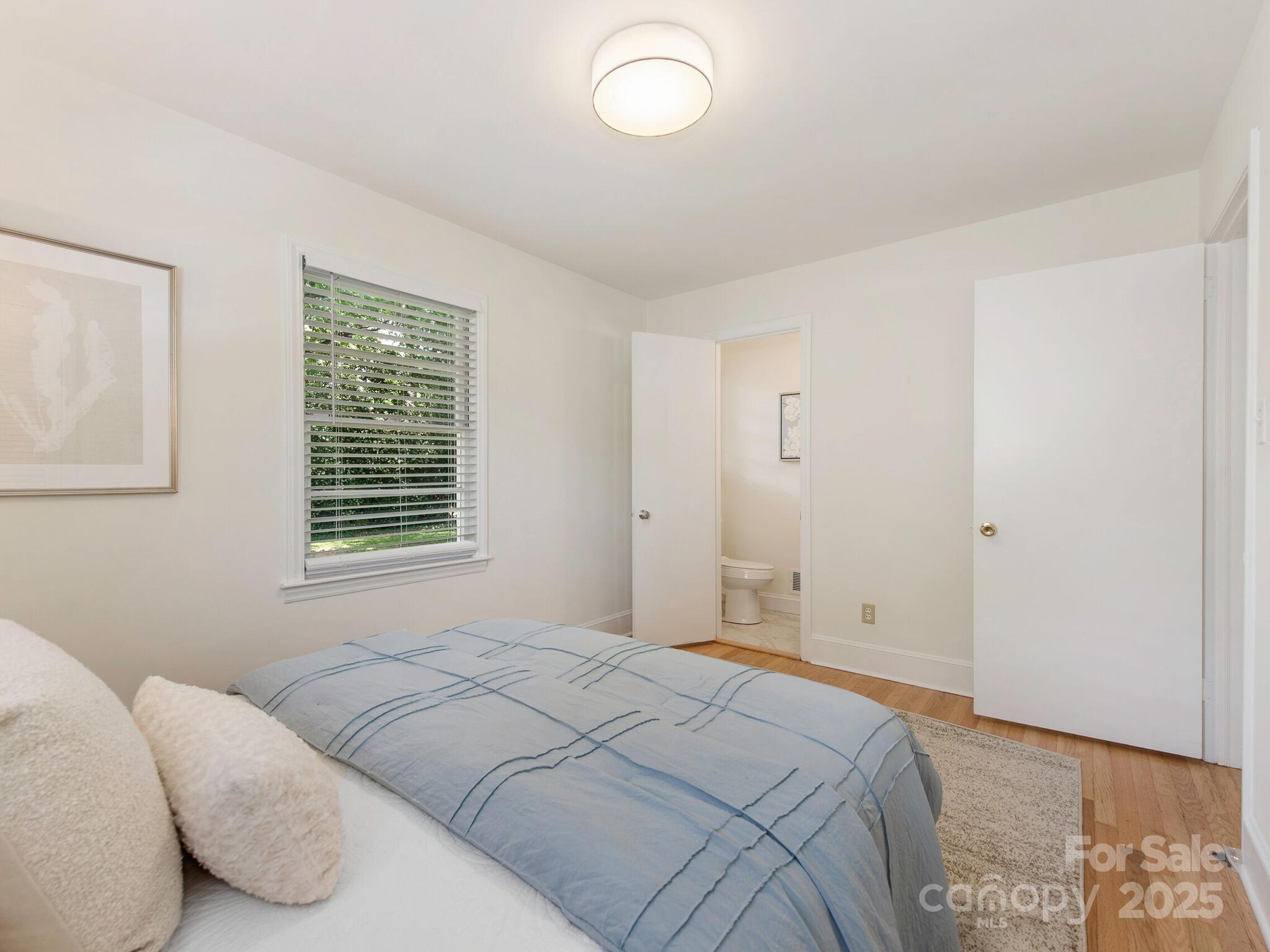 1422 Burnley Road Charlotte, NC 28210 - Photo 19 of 29 a bedroom with a bed and a window