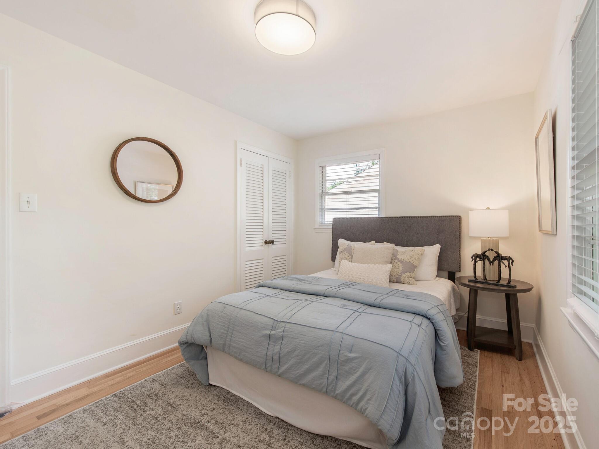 1422 Burnley Road Charlotte, NC 28210 - Photo 21 of 29 a bedroom with a bed and a window