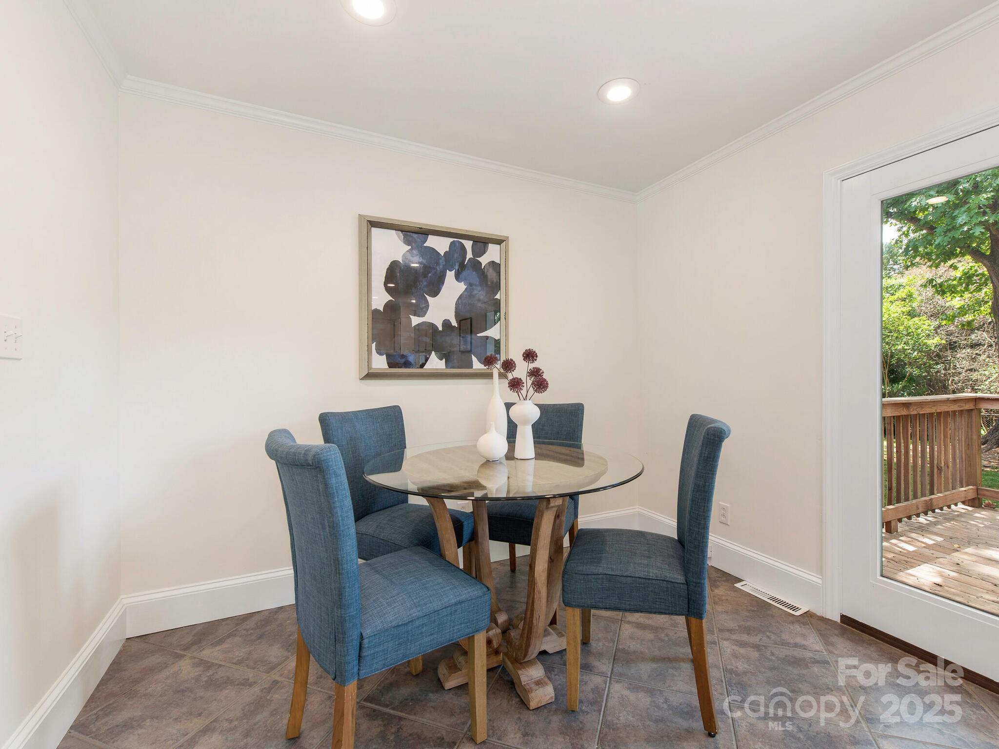 1422 Burnley Road Charlotte, NC 28210 - Photo 22 of 29 a view of a dining room with furniture and a potted plant