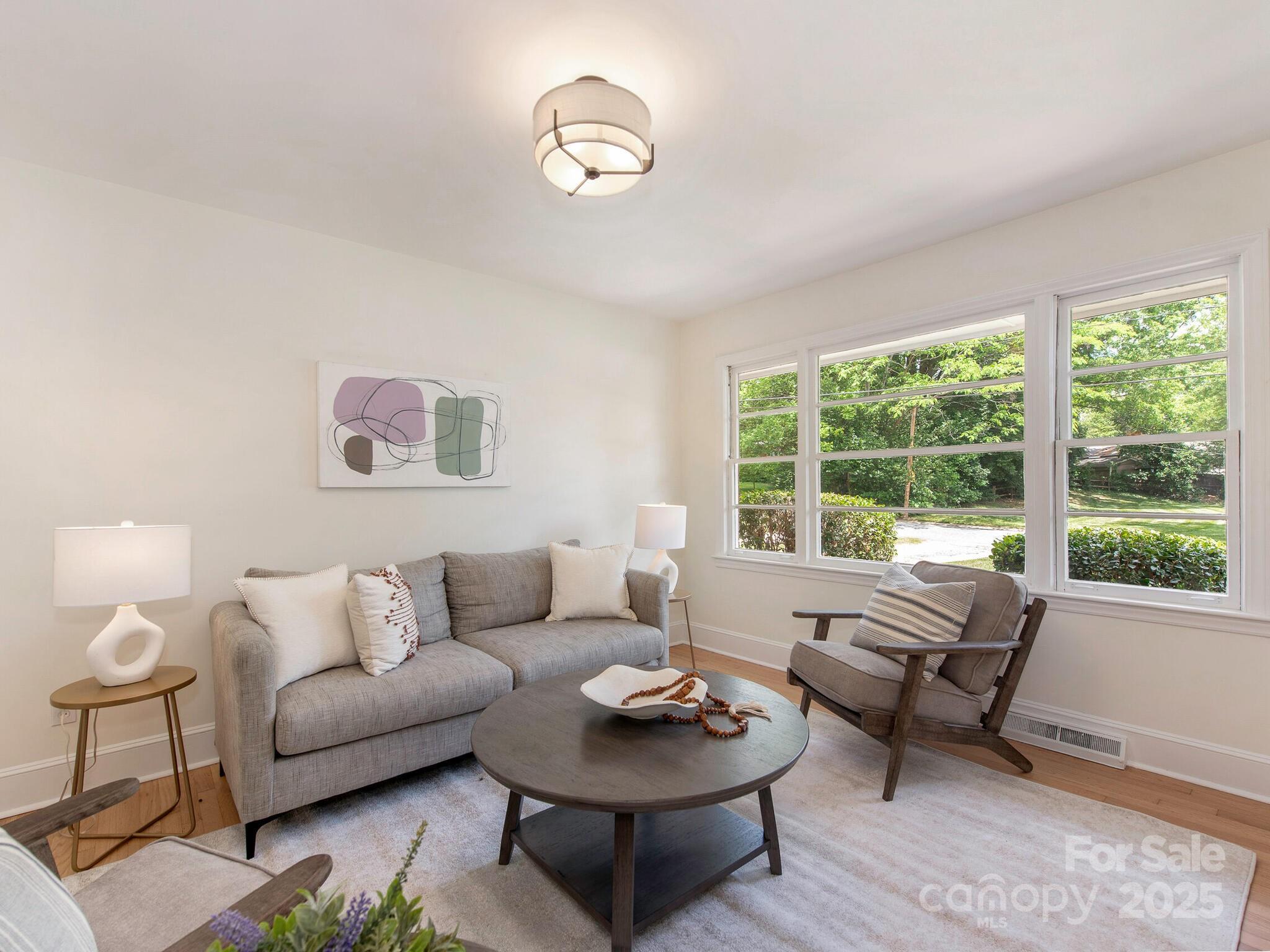 1422 Burnley Road Charlotte, NC 28210 - Photo 5 of 29 a living room with furniture and a large window